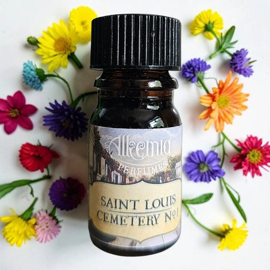 A small amber glass perfume bottle with a black ribbed cap and a cream label reading 'Alkemio Perfumes Saint Louis Cemetery No.1', surrounded by colorful artificial flowers on a white background.
Alkemia Saint Louise Cemetery No. 1 fragrance samples UK 1ml sample available 