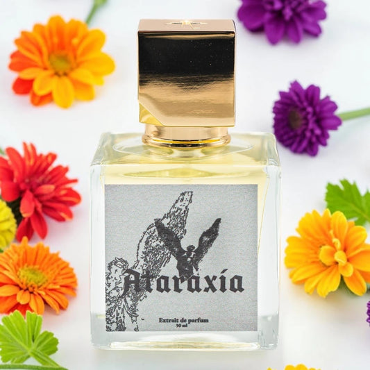 A square glass perfume bottle with a reflective gold cap, filled with pale yellow liquid. The front label reads 'Ataraxía' with a black winged figure illustration on a gray background. Ataraxia Vestibule | Fragrance Sample UK 1ml 2ml 5ml perfume samples 