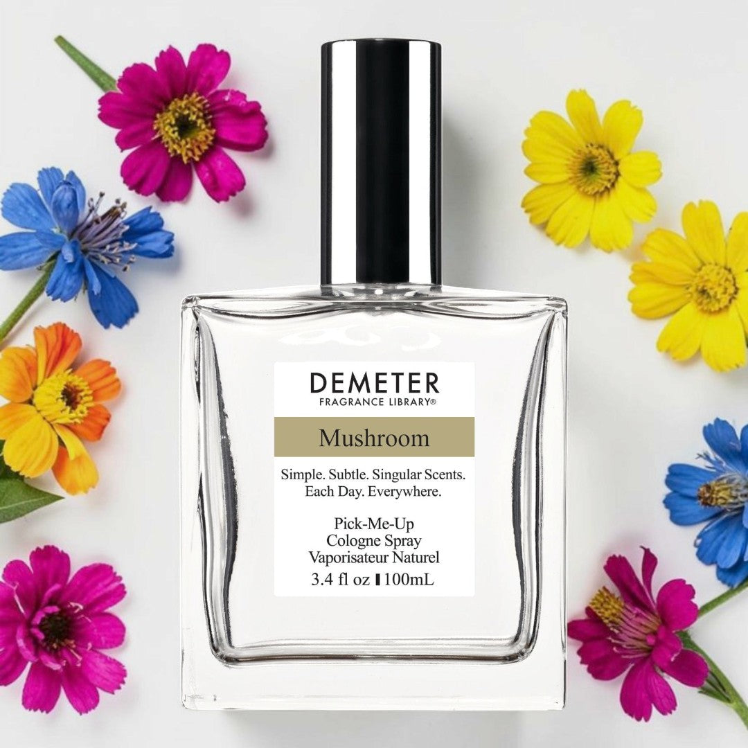 A bottle of Demeter Fragrance Library Mushroom cologne spray, surrounded by colorful flowers on a white background. Demeter Fragrance Library Mushroom | Fragrance Samples UK 1ml 2ml and 5ml perfume samples available 
