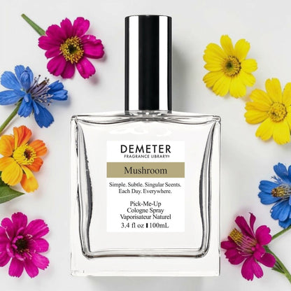 A bottle of Demeter Fragrance Library Mushroom cologne spray, surrounded by colorful flowers on a white background. Demeter Fragrance Library Mushroom | Fragrance Samples UK 1ml 2ml and 5ml perfume samples available 