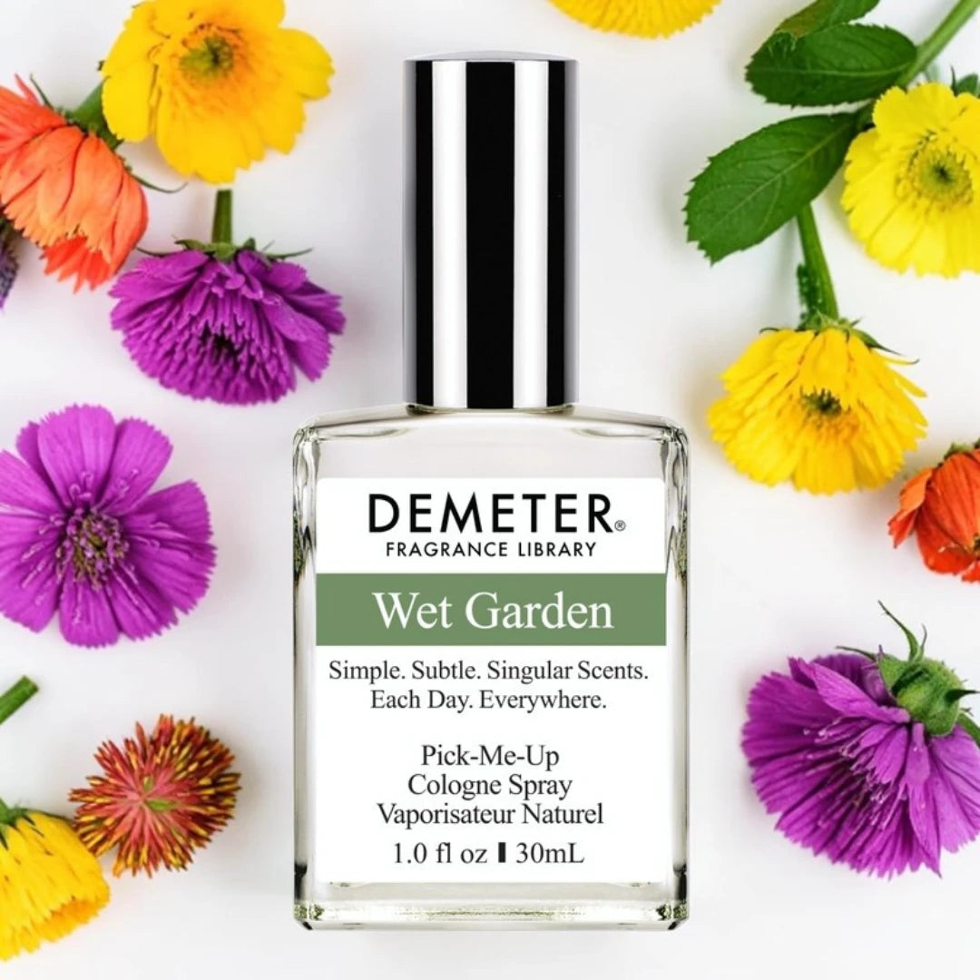 A bottle of Demeter Wet Garden fragrance scents, surrounded by colorful flowers on a white background. Demeter Fragrance Library Wet Garden Fragrance Samples UK 1ml 2ml 5ml samples available 