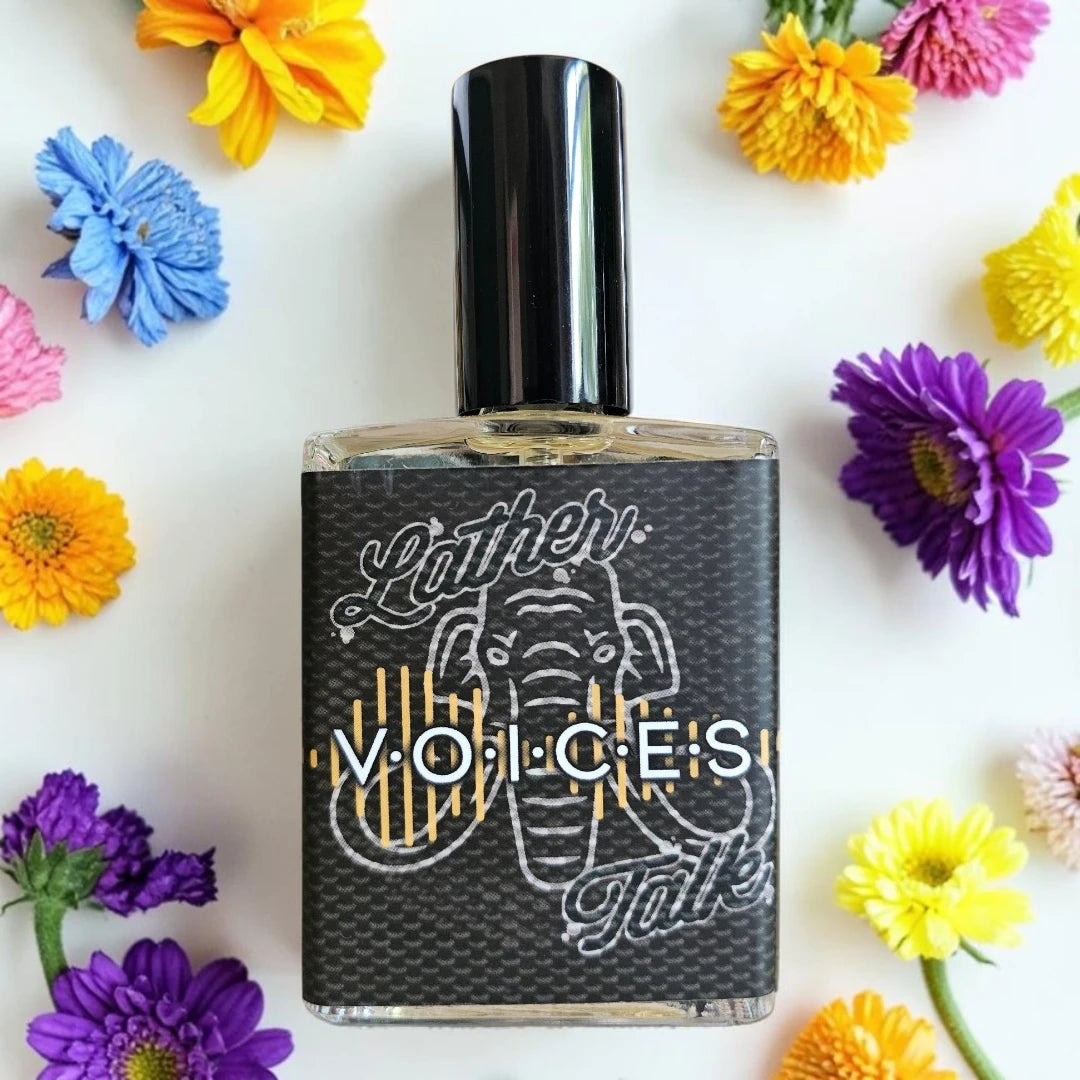 A rectangular glass perfume bottle with a black cap and a black label featuring an elephant illustration and the text 'Voices', surrounded by colorful flowers on a white background.
House Of Mammoth Voices | Fragrance Samples UK 1ml 2ml 5ml samples available 