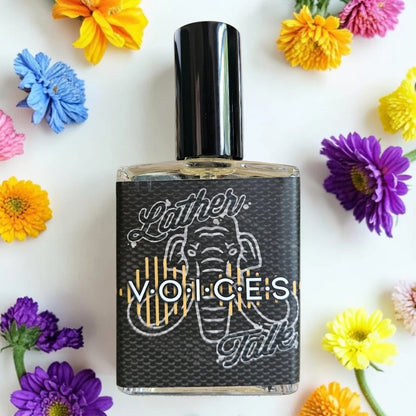 A rectangular glass perfume bottle with a black cap and a black label featuring an elephant illustration and the text 'Voices', surrounded by colorful flowers on a white background.
House Of Mammoth Voices | Fragrance Samples UK 1ml 2ml 5ml samples available 