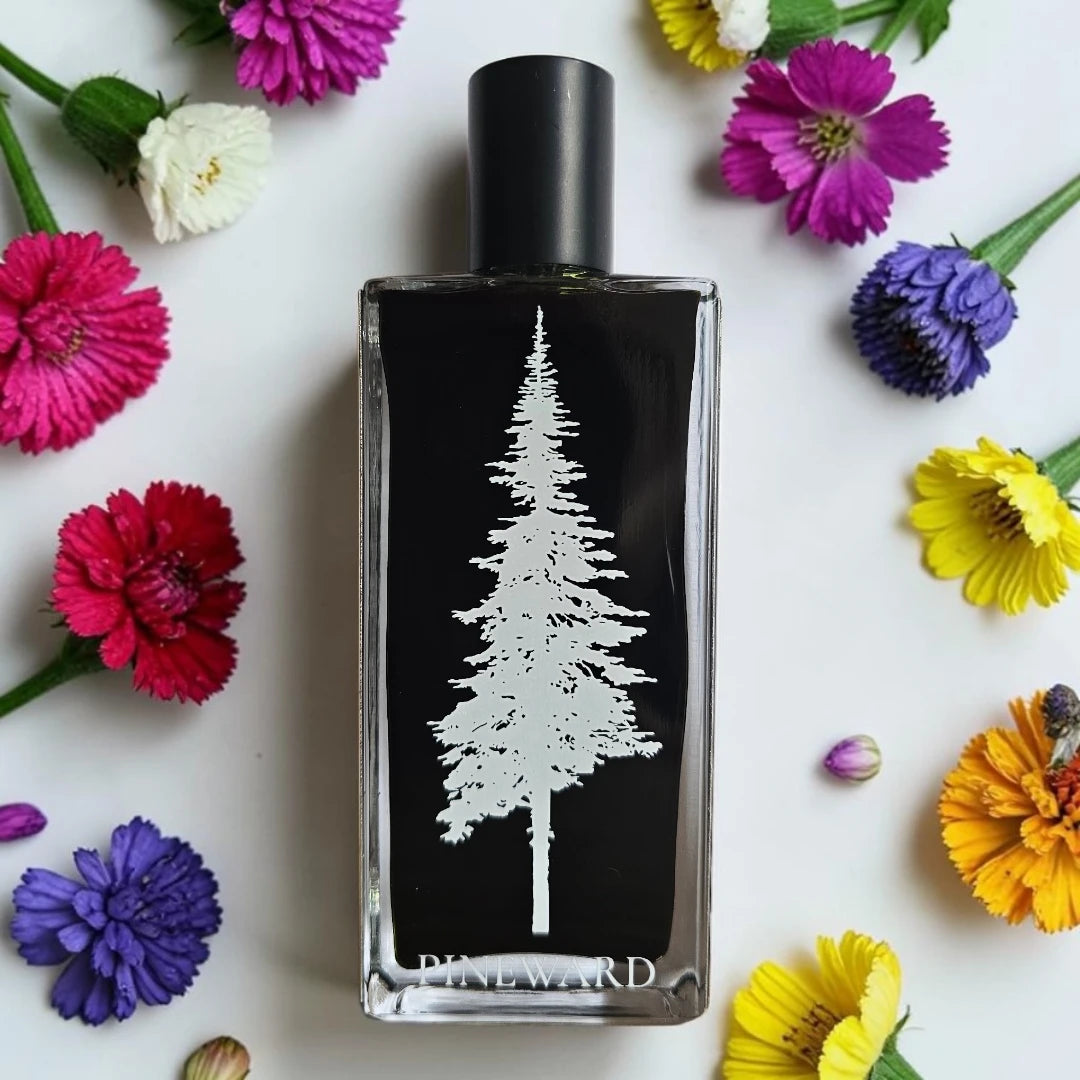 A rectangular glass perfume bottle with a black label featuring a white pine tree design and the brand name 'PINEWARD' at the bottom, surrounded by colorful flowers on a white background.
Pineward Fanghorn 2 | Fragrance Samples UK available in 1ml 2ml 5ml samples 