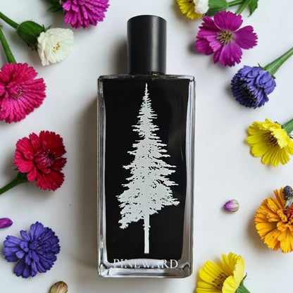 A rectangular glass perfume bottle with a black label featuring a white pine tree design and the brand name 'PINEWARD' at the bottom, surrounded by colorful flowers on a white background.
Pineward Fanghorn 2 | Fragrance Samples UK available in 1ml 2ml 5ml samples 