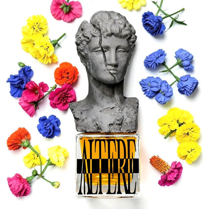 A perfume bottle labeled 'ALTERE' with a gray stone bust sculpture on top, surrounded by colorful flowers in yellow, pink, blue, and orange on a white background. Profundum Altere | Fragrance Sample UK 1ml 2ml and 5ml perfume samples available
