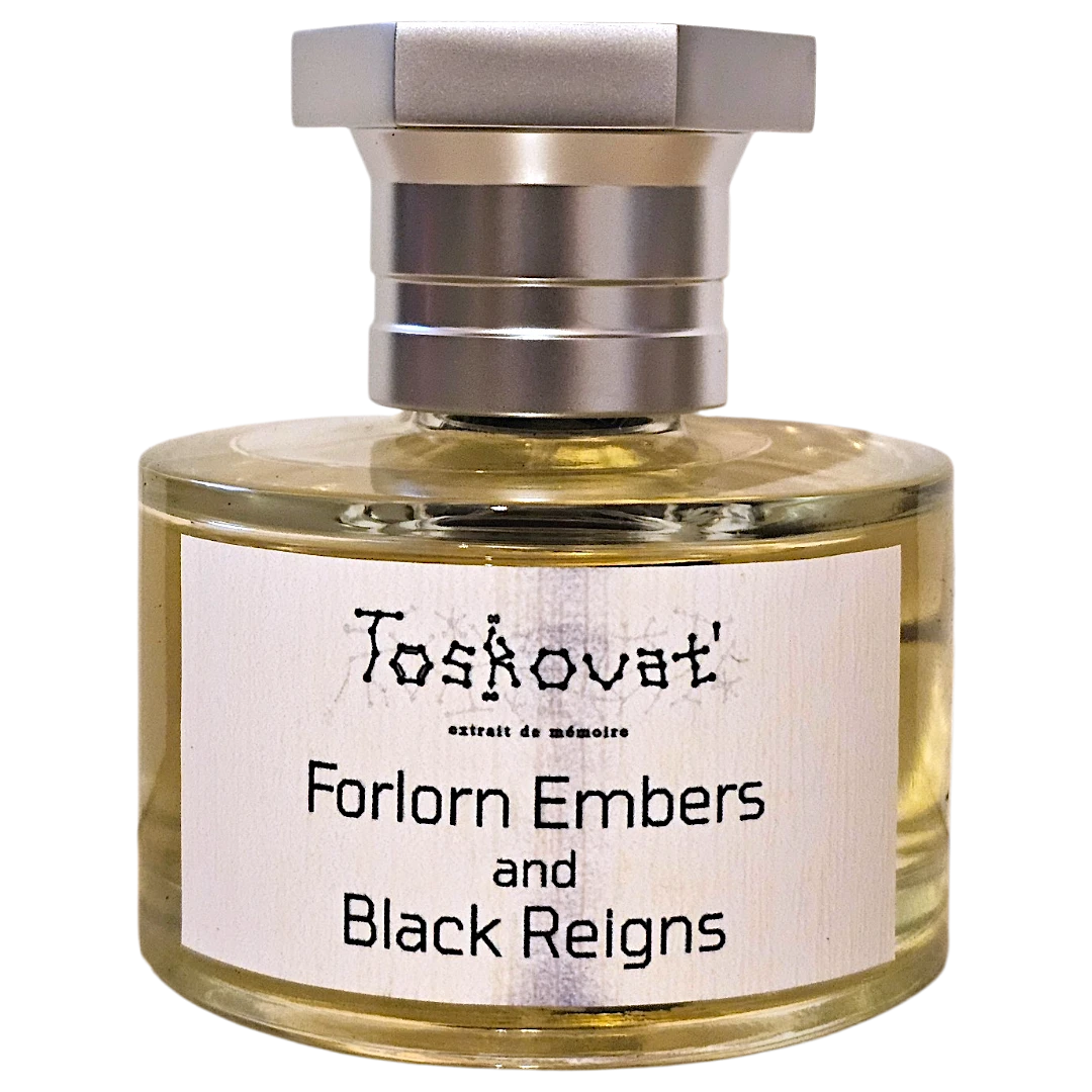 A bottle of Toskovat 'Forlorn Embers and Black Reigns' fragrance, featuring a clear glass bottle with pale yellow liquid, a white label with black text, and a silver-toned metal cap, isolated on a white background.