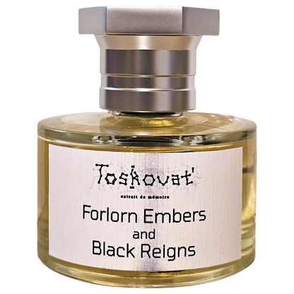 A bottle of Toskovat 'Forlorn Embers and Black Reigns' fragrance, featuring a clear glass bottle with pale yellow liquid, a white label with black text, and a silver-toned metal cap, isolated on a white background.