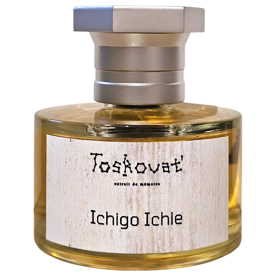 A bottle of Toskovat 'Ichigo Ichie' memory perfume with a silver cap and a light wood-grain label, containing a golden-yellow liquid, isolated on a white background.
