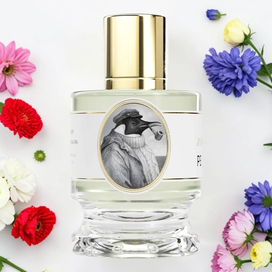 A clear glass perfume bottle with a shiny gold cap and a white label featuring a black-and-white illustration of a bird wearing a hat and sweater. The bottle is centered on a white background and surrounded by colorful flowers in pink, red, yellow, blue, and purple.
Zoologist Penguin | Fragrance Samples UK 1ml 2ml and 5ml perfume samples available