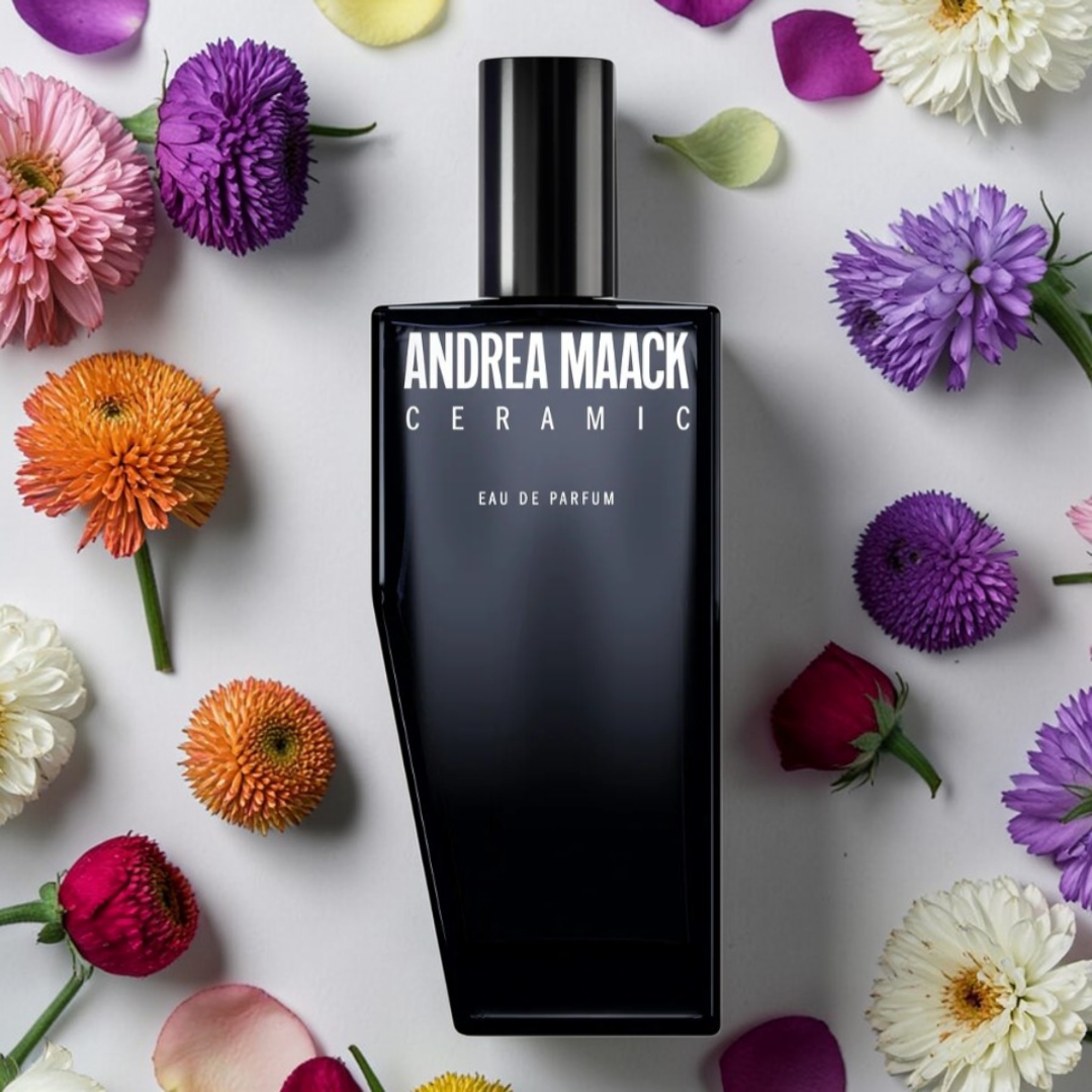 Andrea Maack ceramic fragrance sample bottle surrounded by colorful flowers.