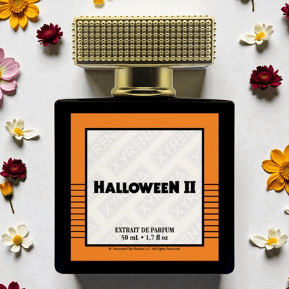 Xyrena Halloween ll Fragrance Samples bottle displayed with flowers, featuring autumn fruits and a haunting scent.